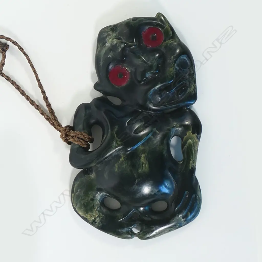 Māori carved pounamu hei tiki with well-defined features Image 1++