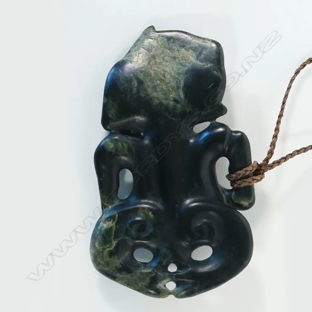 Māori carved pounamu hei tiki with well-defined features Image 1++