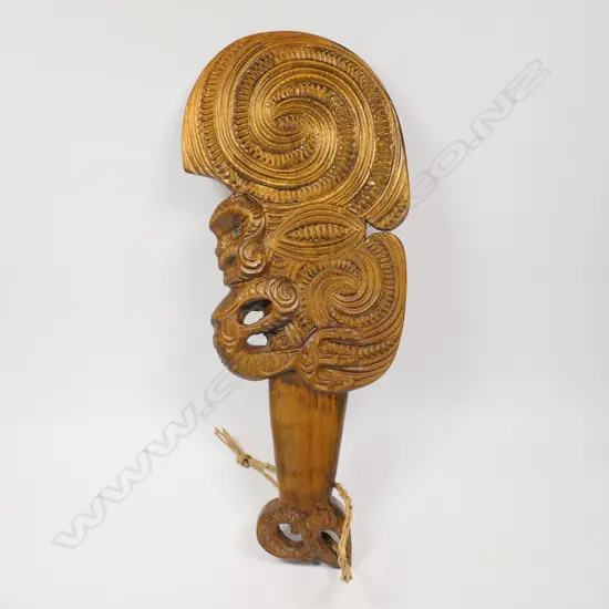 A Māori carved wahaika, double and triple scroll carved blade, full figure to one edge, weku carved butt. c.1980.