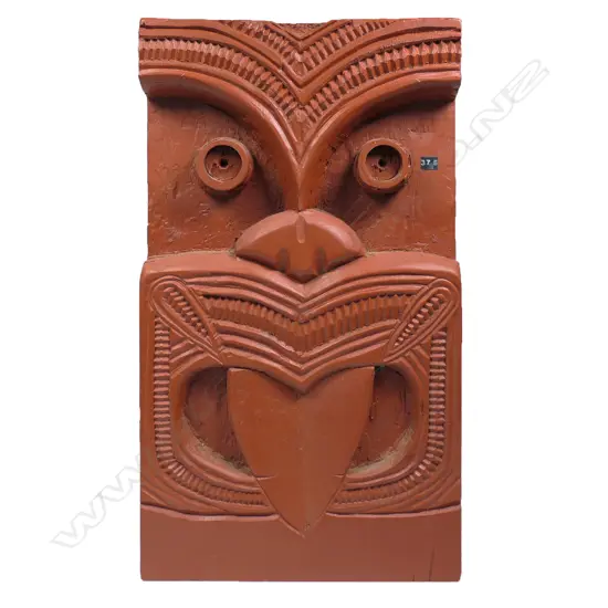 A vintage Māori carved stylised mask panel,