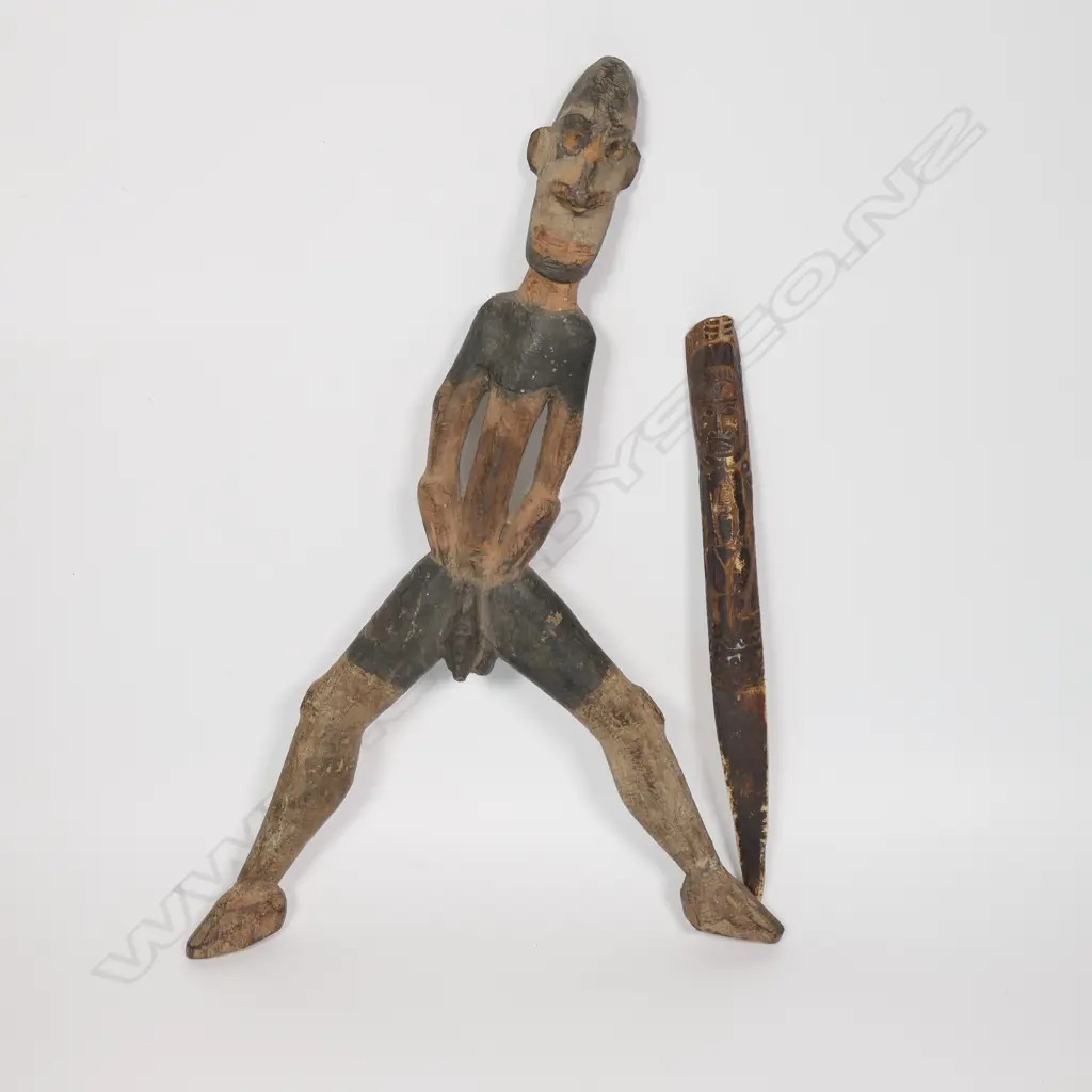 A PNG early 20thC carved Cassowary Bird bone dagger and a carved Sepik River male figure, Image 1++