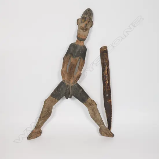 A PNG early 20thC carved Cassowary Bird bone dagger and a carved Sepik River male figure,