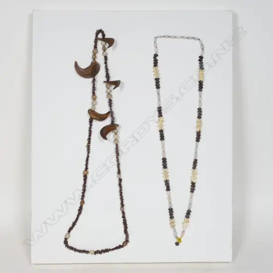 A Snake vertebrae and wild purple banana seed necklace plus one other seed necklace,