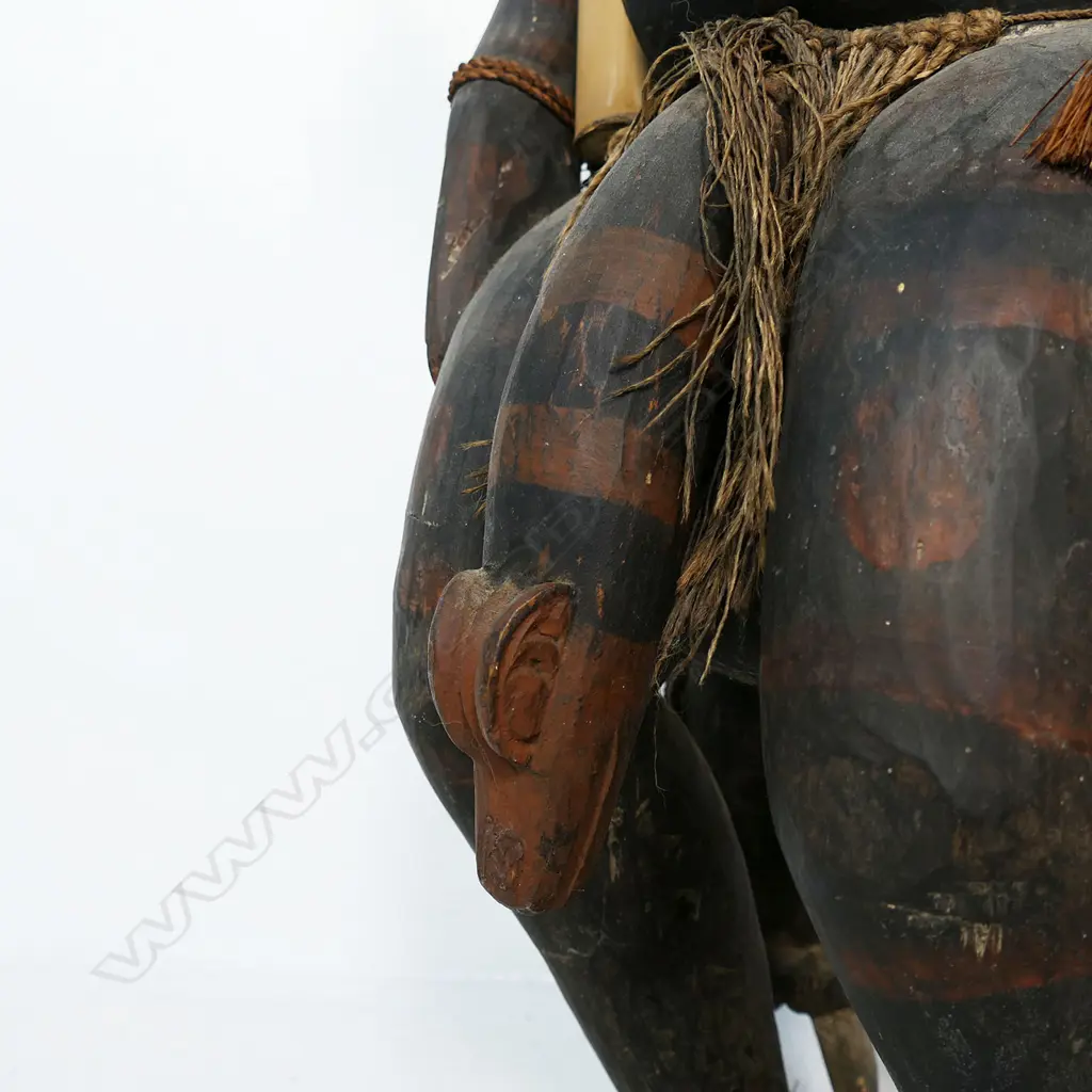 A PNG Orator figure on a stool with supporting figures, Image 1++