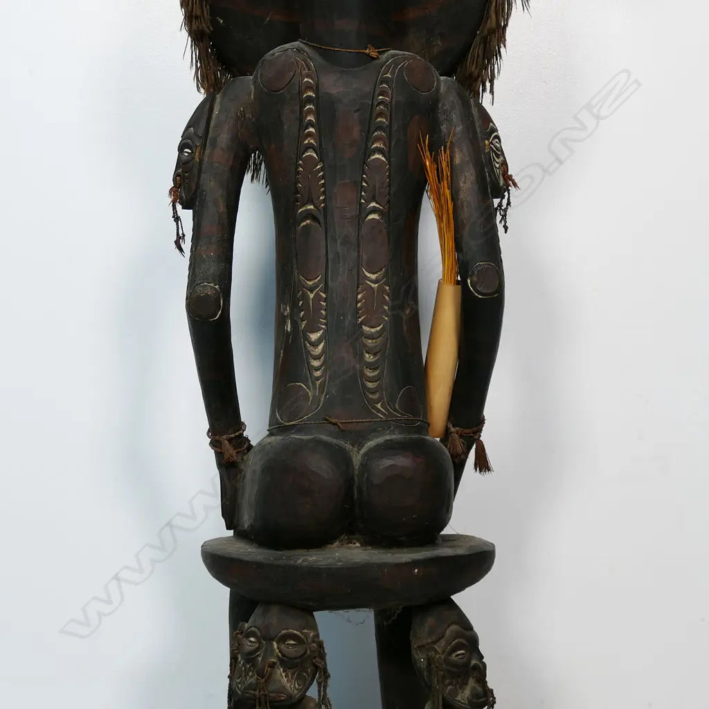 A PNG Orator figure on a stool with supporting figures, Image 1++
