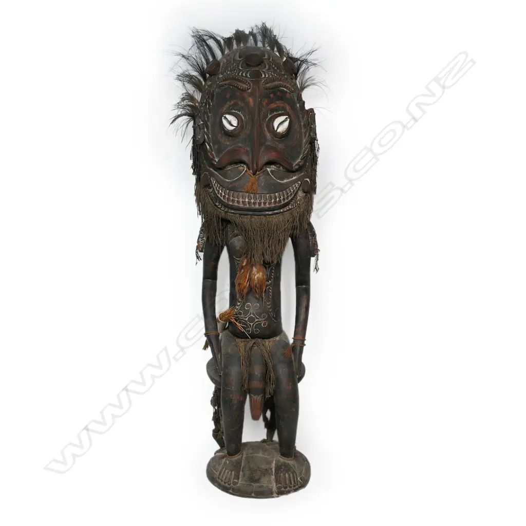 A PNG Orator figure on a stool with supporting figures, Image 1++
