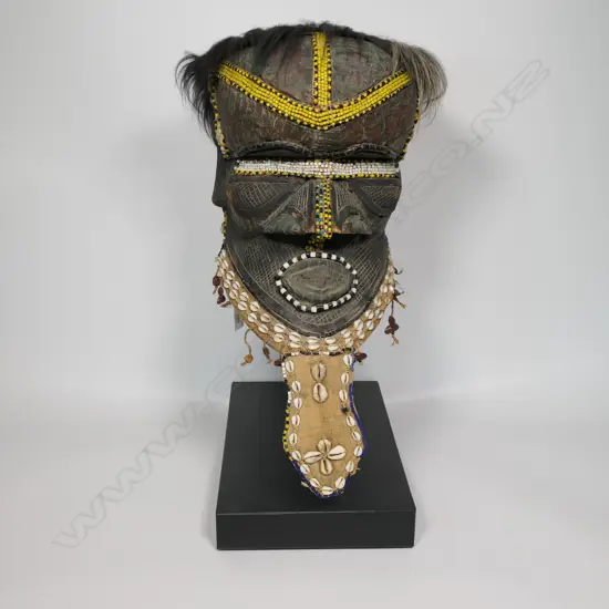 A Namibian mask on stand with copper metal foil & shells,