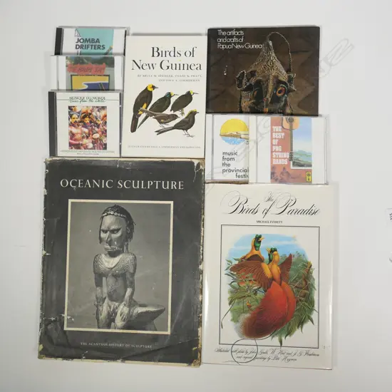 Four assorted books about birds and artifacts of PNG and five CD PNG music,
