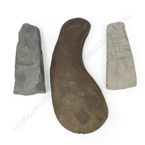 An unusual shaped stone club; a stone adze and a part adze,