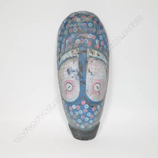 An African carved and painted wooden mask,