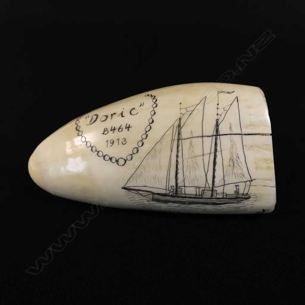 A contemporary scrimshaw whale tooth by Jorgen Lotz, engraved with 'Pearling Lugger, Broome, WA' and 'Doric, b464, 1913' (a ketch rigged yacht). Monogrammed 'JL'. L.130mm. Provenance: The Jorgen Lotz Collection. Image 1++