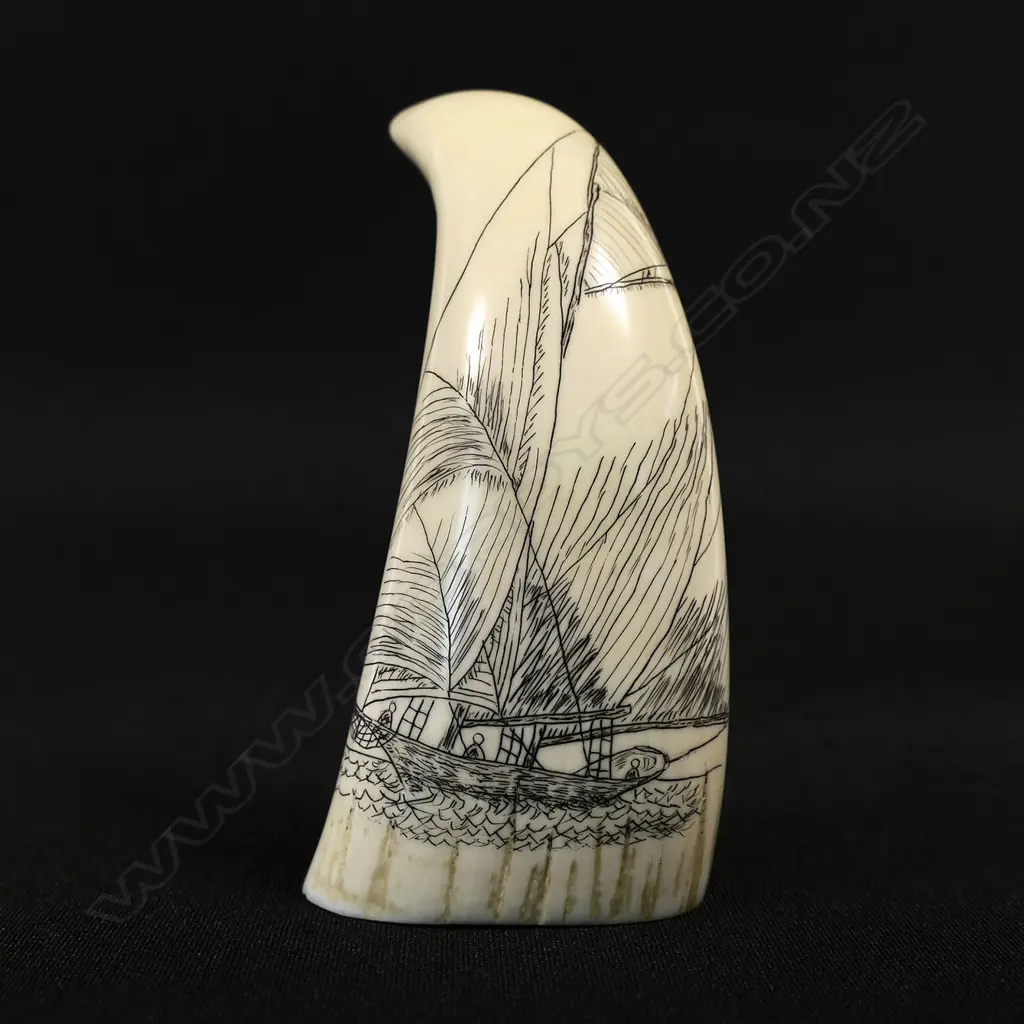 A small contemporary scrimshaw whale tooth Image 1++