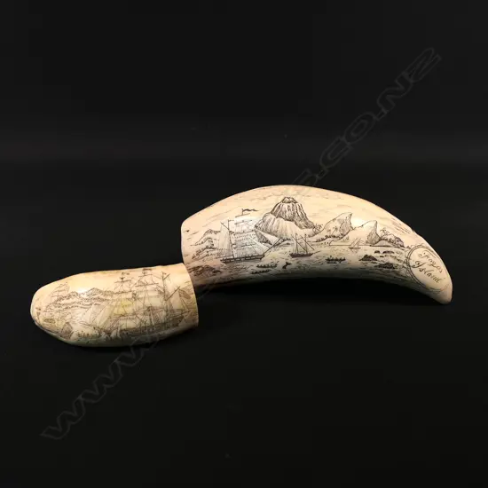 Two scrimshaw replica whales teeth