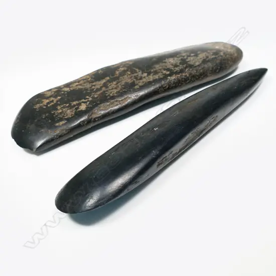 Two pecked and polished black stone bride price celts / wealth objects