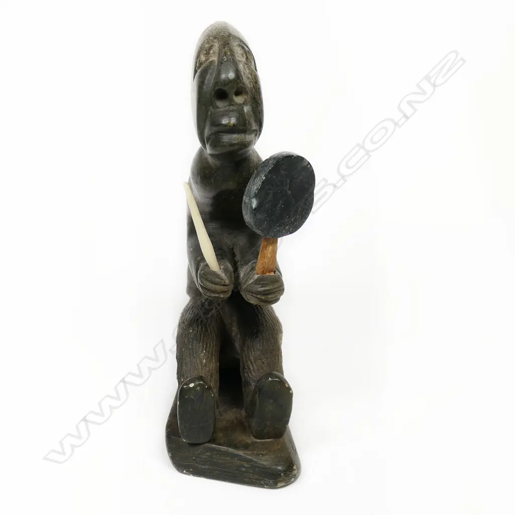 An Inuit stone carving of a shaman drummer Image 1++