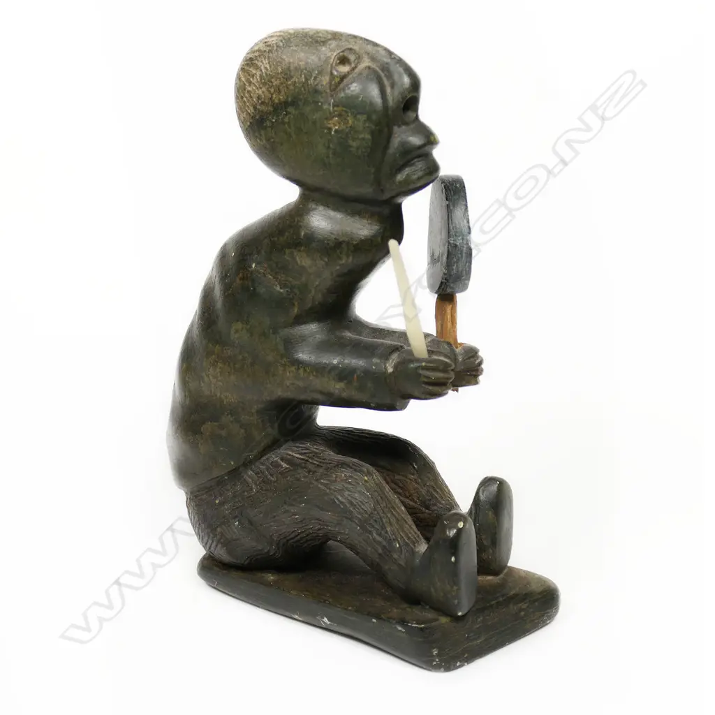 An Inuit stone carving of a shaman drummer Image 1++