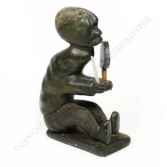An Inuit stone carving of a shaman drummer