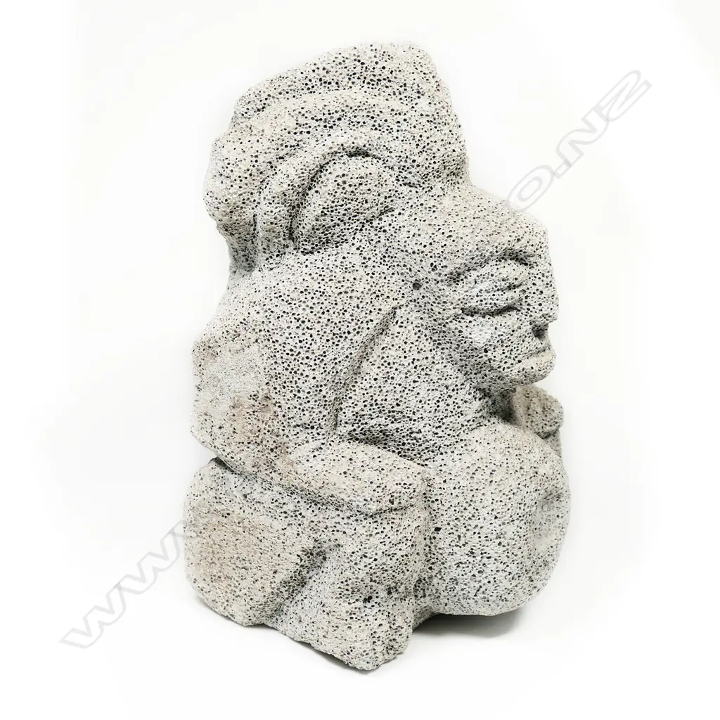 A carved pumice small statue of an Aztec deity wearing a plumed headdress Image 1++