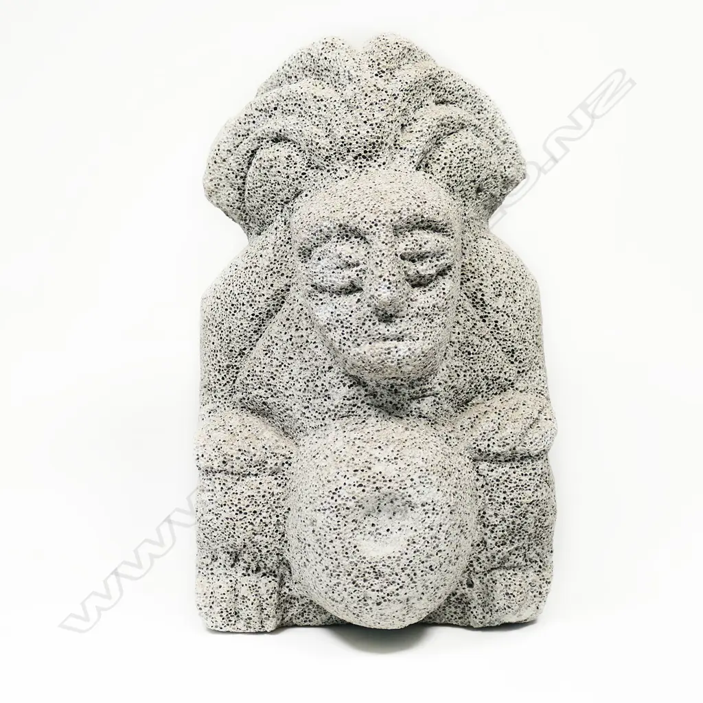 A carved pumice small statue of an Aztec deity wearing a plumed headdress Image 1++