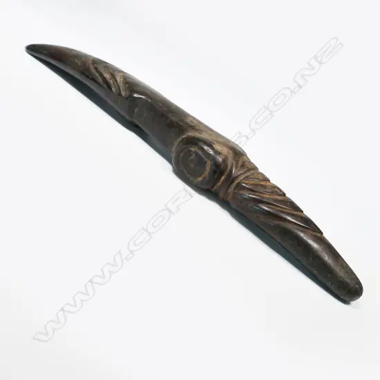 A large and decorative ceremonial adze blade