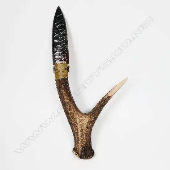 A striated glass pressure-flaked spear-point knife blade