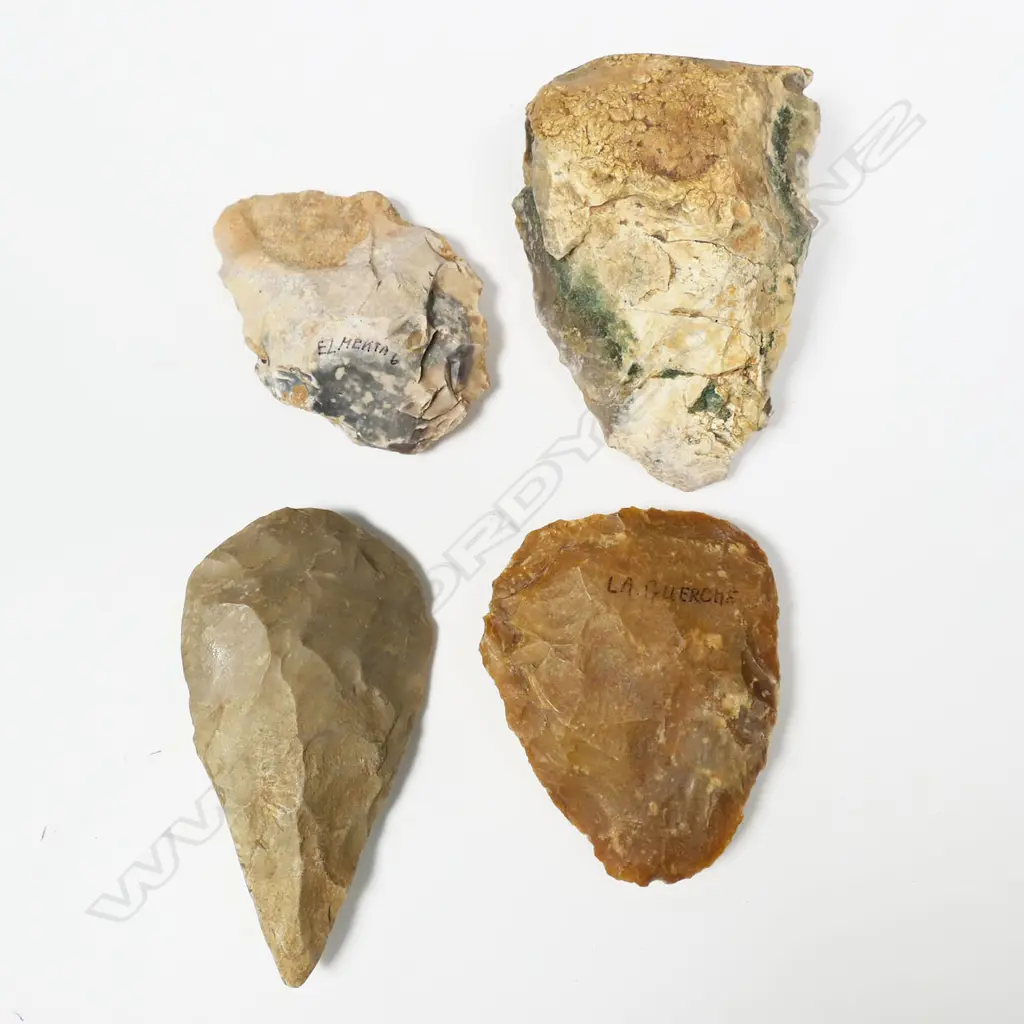 Four Neolithic flaked stone tools, three with location inscribed. 'Dchira, Mauritanien 300,000 AR' (Western Sahara); 'La Guerche' (Indre-et-Loire, France); 'El Mekta 6 (Settat, Morocco); the fourth unnamed but described on sale in 2013 as 'Upper Paleolithic Flint, Abbevillian bifacial, amigdala' from Saharan Sudan (El-Fasher)'. Longest 120mm. Provenance: The Jorgen Lotz Collection. Image 1++