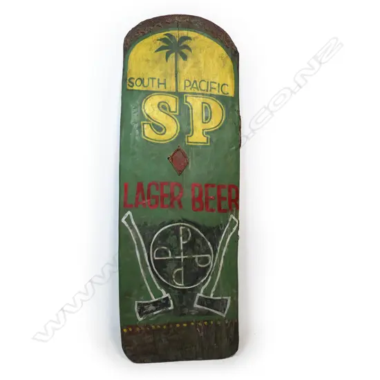 A PNG Highlands Wahgi Valley 'SP Beer' shield, decorated with 'South Pacific SP Lager Beer' details above a symbol flanked by axes. H.1450mm. W.295mm. Note: During the 1980's warfare re-asserted itself in the New Guinea Highlands, the first generation of educated warriors began to use 'new' motifs that often-used words. Designs incorporating Coca-Cola, Pepsi-Cola and SP Beer appeared. This shield with the SP Beer logo also incorporates two metal axes, part of the new armoury of new weapons in warfare. Soon after guns began to be used, and the wooden shields in the main Wahgi Valley all but ceased by about 2000. Provenance: Purchased from Chris Boylan Oceanic Art 2022 for $3,800. The Jorgen Lotz Collection.