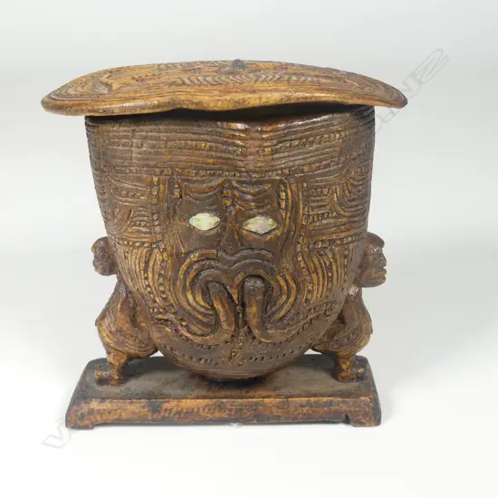 An old Māori carved wooden small figure supported lidded box