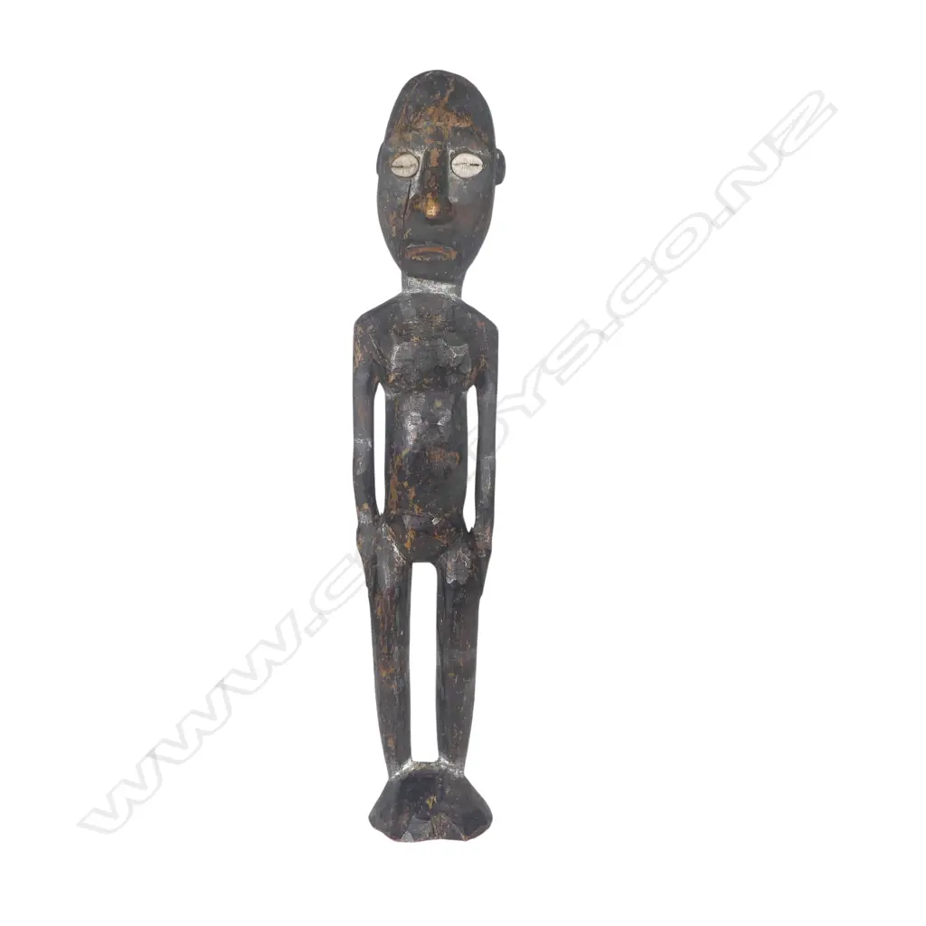 An old Solomon Islands carved wood figure with dark pigment finish Image 1++