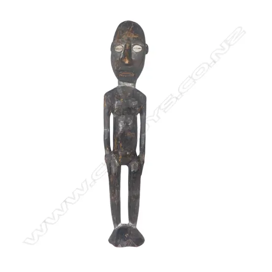 An old Solomon Islands carved wood figure with dark pigment finish