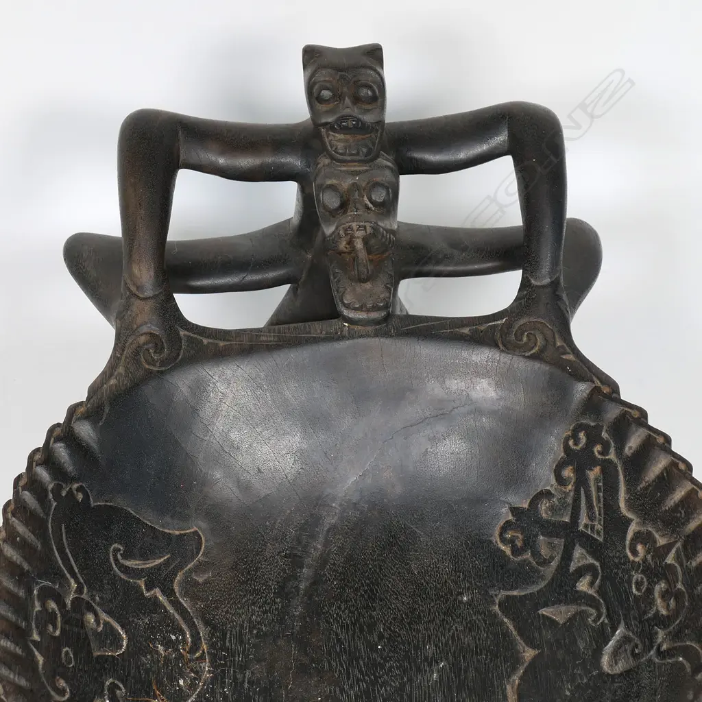 An Indonesian figure supported large wooden bowl with five small tribal figures Image 1++