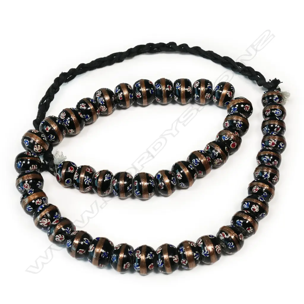 A long strand of coloured glass trade beads Image 1++