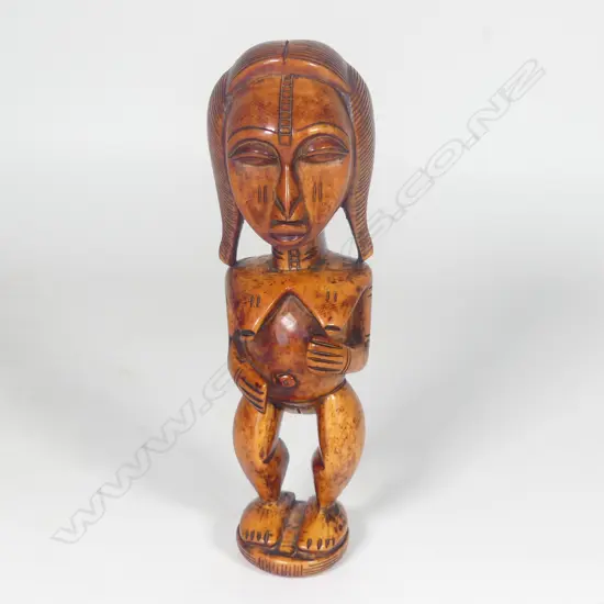 A Yoruba Benin Ere Ibeji solid ivory carved female figure