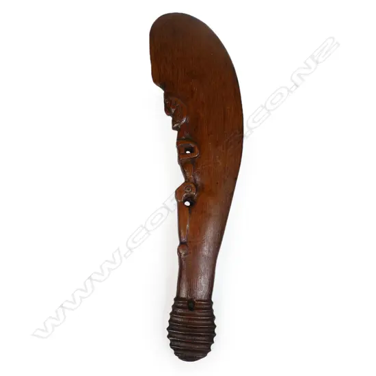 A 20thC Māori carved wahaika with stylised figure to back of blade,