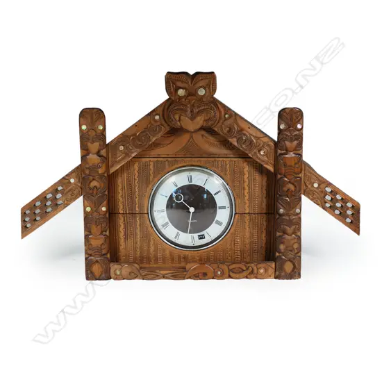 A large c.1950's Māori whare carved frame mantle clock,