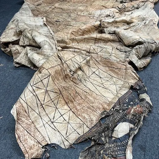A large old tapa in distressed condition,