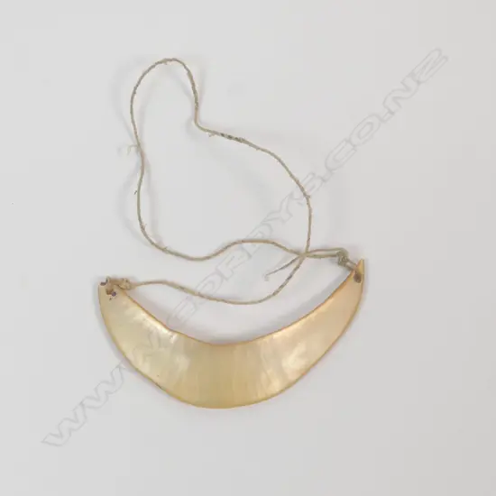 A pearl shell breast plate,