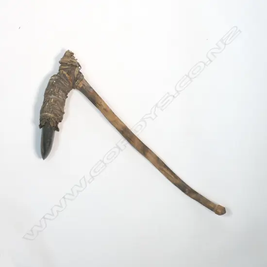 A hafted stone adze,