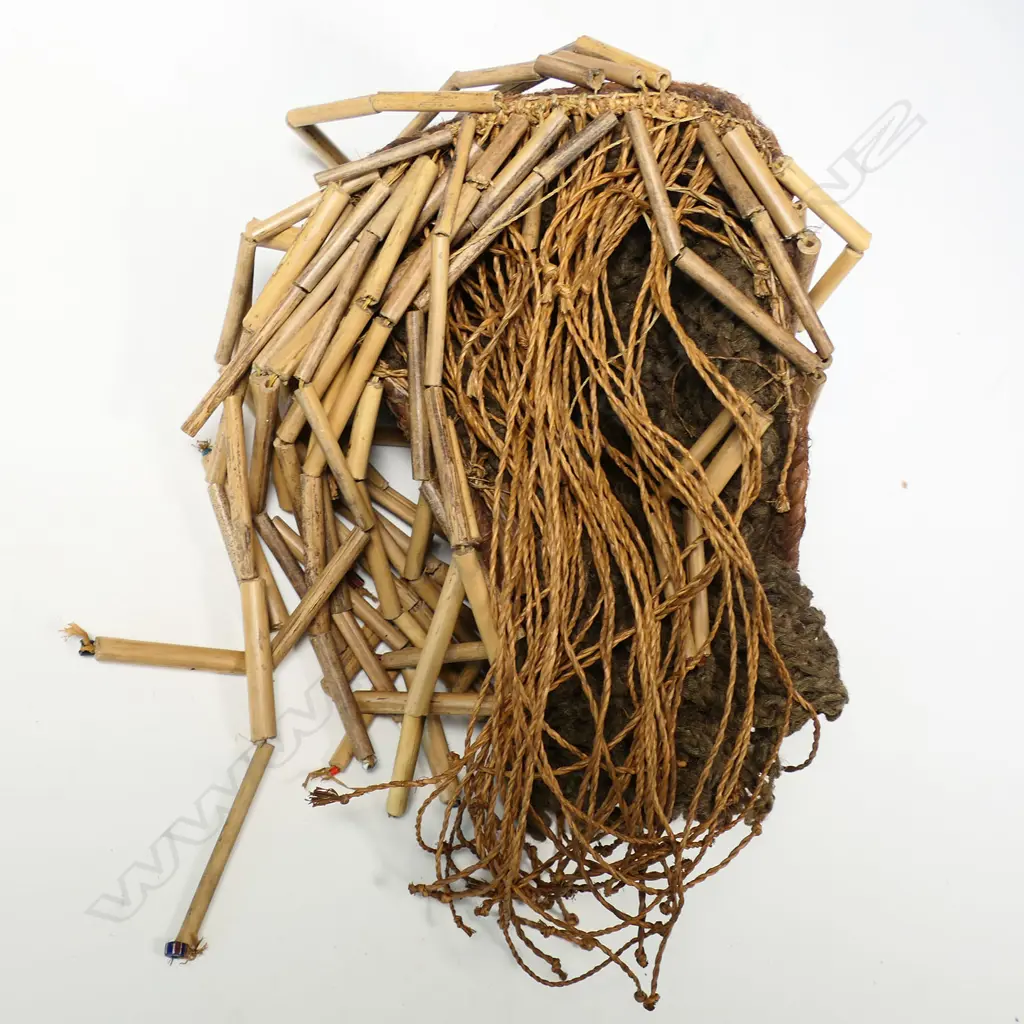 African mask probably Chokwe Mwana Pwo. Carved wood with woven fibre border with bamboo sectional fringe. H.320mm. Provenance: Ex. The Estate of John Perry. Image 1++