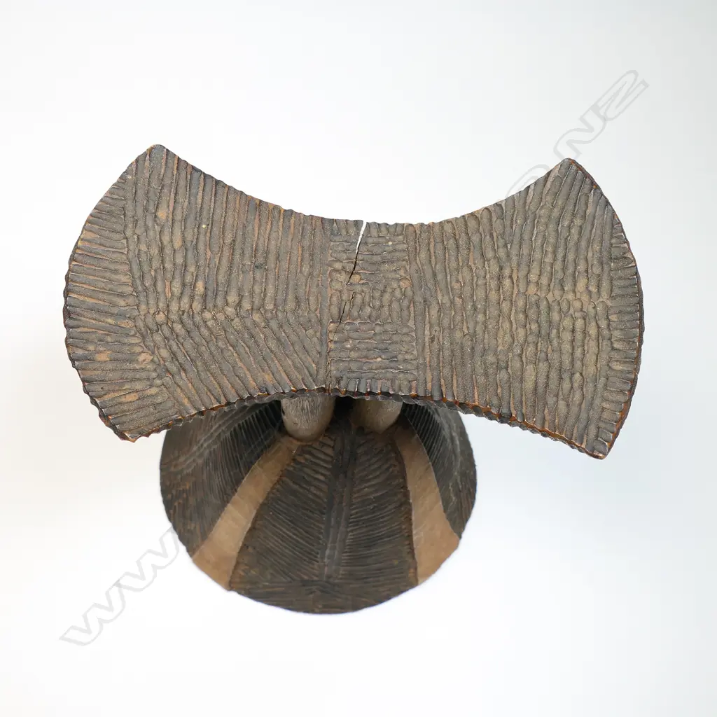 African carved wood headrest fine ridged carved decoration. Bell form base H.200mm.  Provenance: Ex. The Estate of John Perry. Image 1++