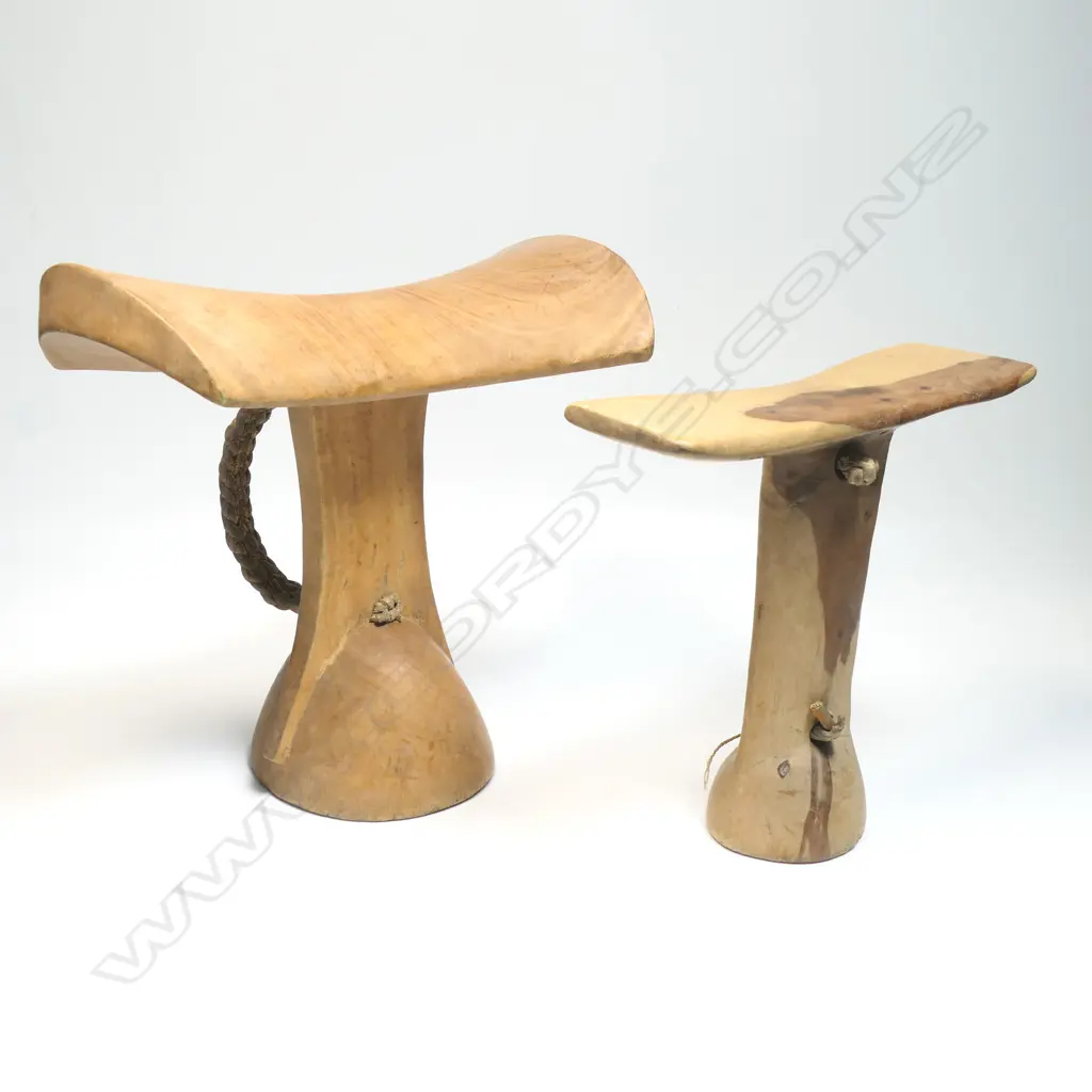 Two African carved wood headrests, bar form supports, pale wood. H's.205 & 165mm. Provenance: Ex. The Estate of John Perry. Image 1++