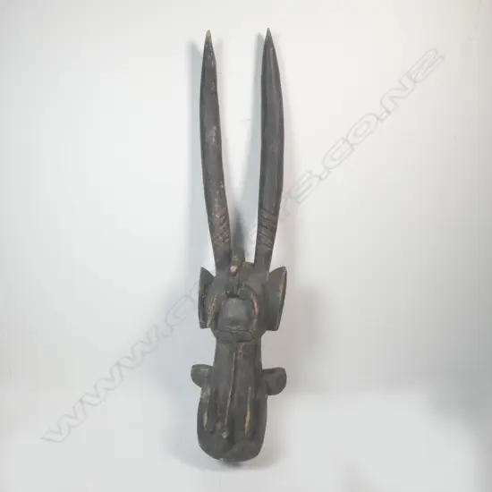 A carved African mask from Ivory Coast