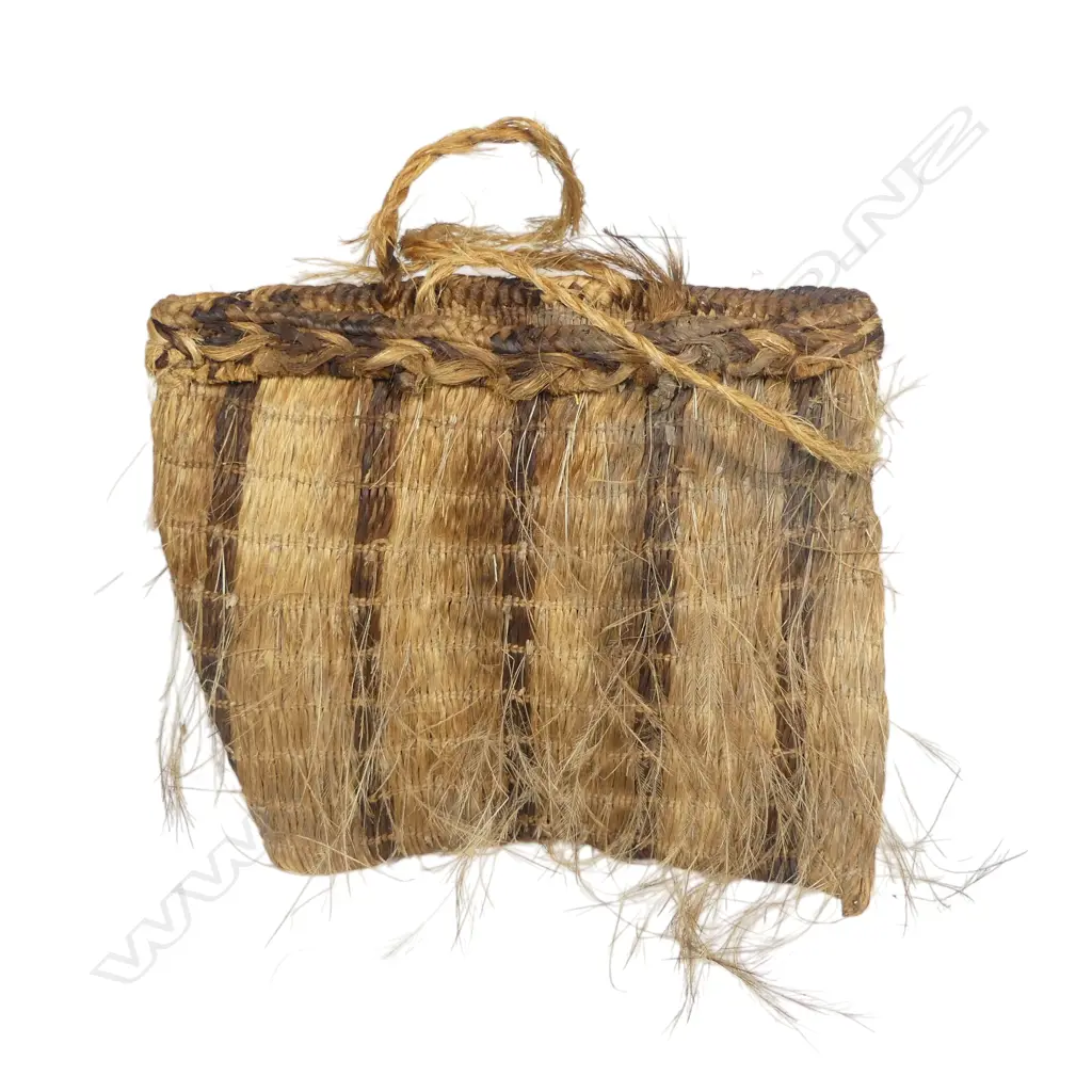 19thC Māori muka kete kiwi, fine wispy feathers sewn to the banded muka body. Handles to the top. 200 x 170mm. Being assessed for registration. Image 1++