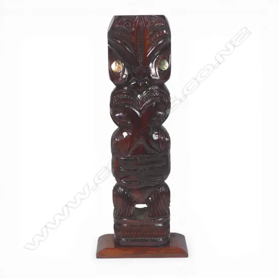 Mid / late 20thC Māori carved standing pou (post/figure), with extended forked tongue and paua disc eyes. Dark stained finish. H.565mm.