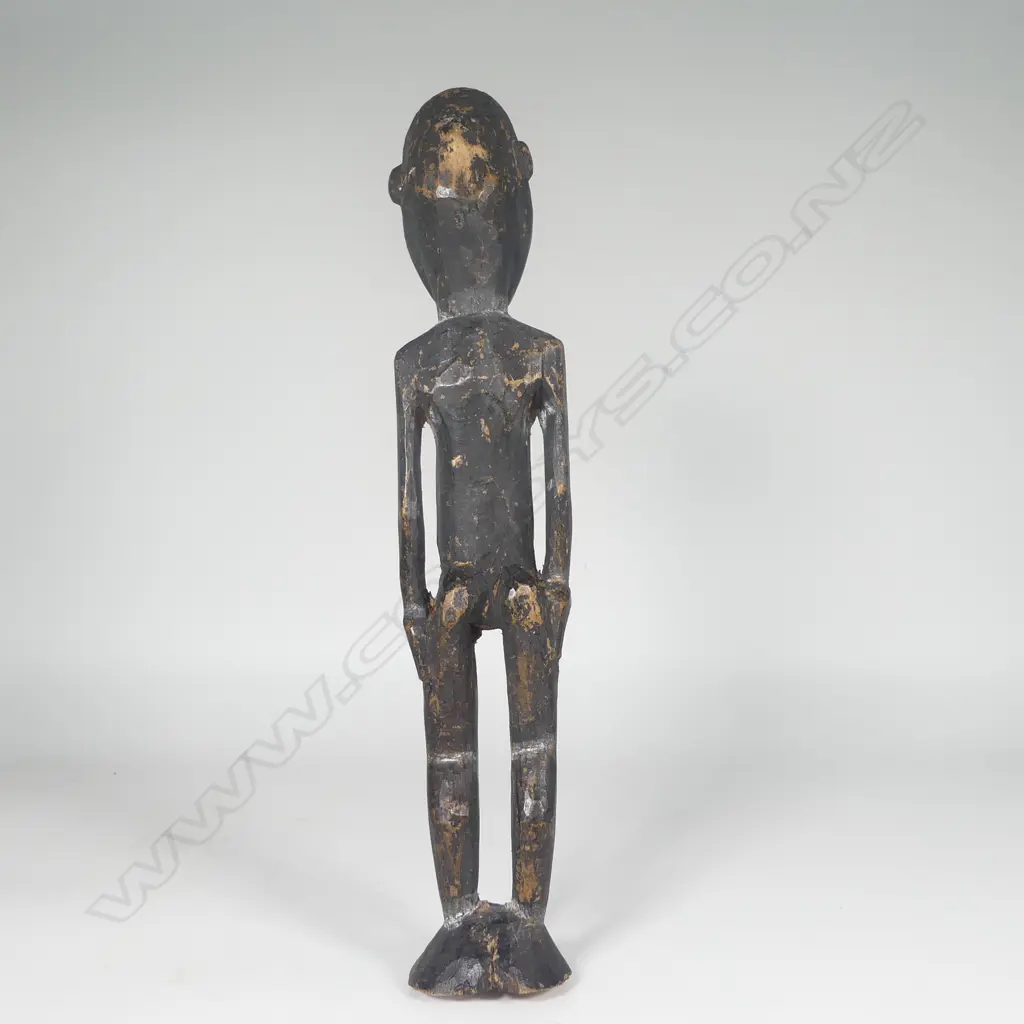 An old Solomon Islands carved wood figure with dark pigment finish Image 1++