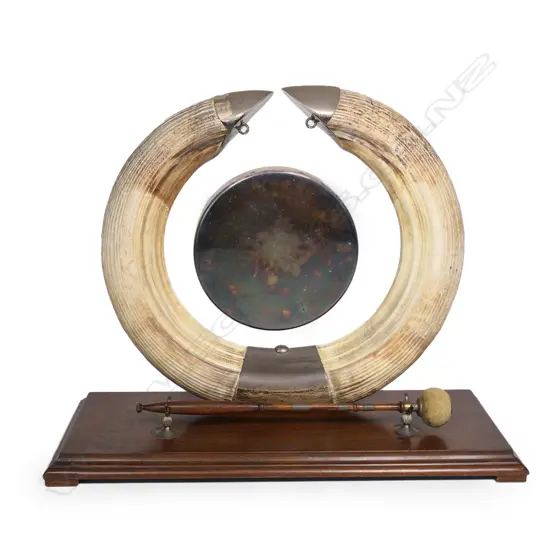 A silver and hippopotamus tusk gong set