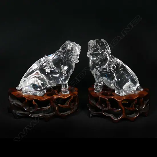 A pair of Chinese carved rock crystal goats on fitted stands,