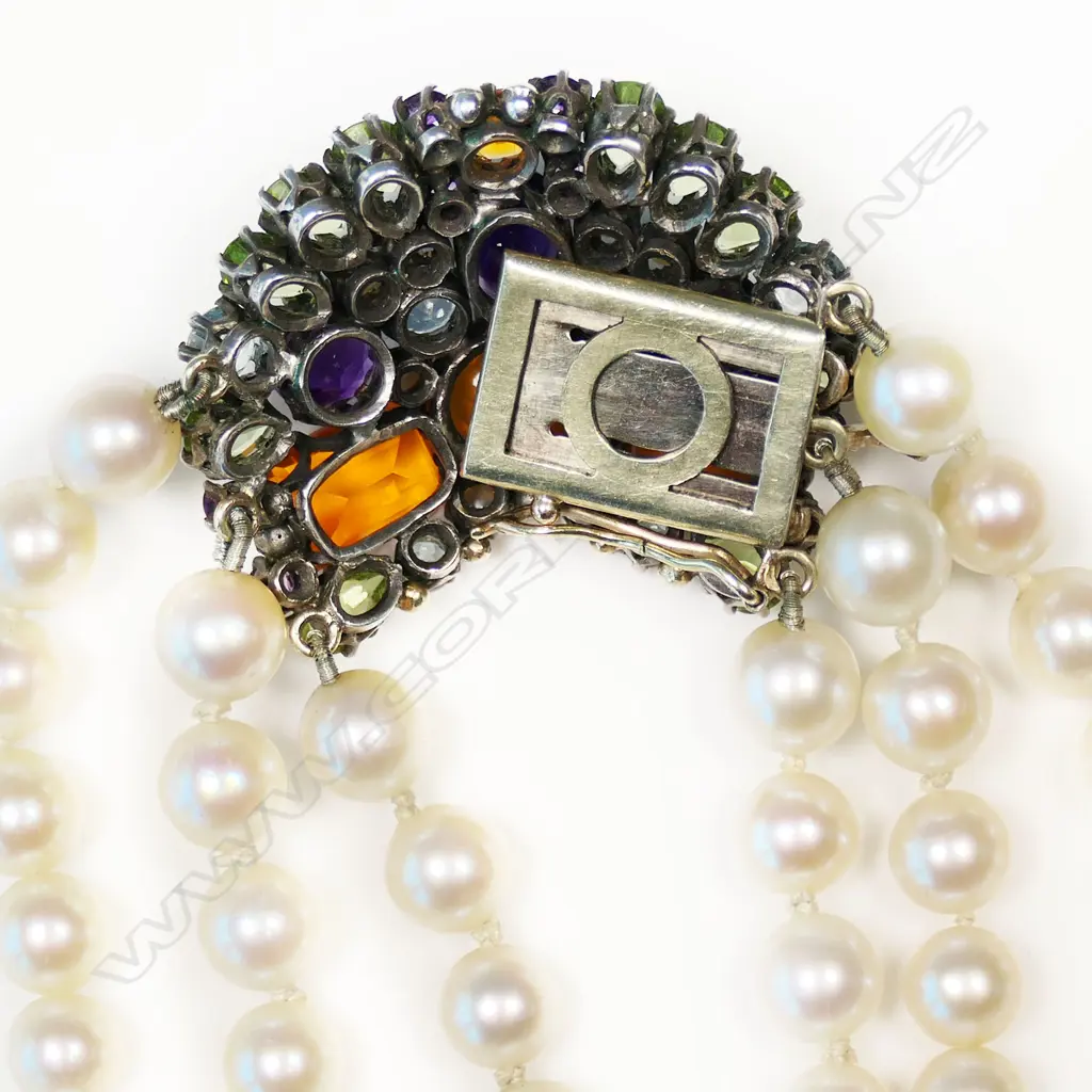 An uncommon triple strand cultured pearl necklace with gem stone clasp by Dorrie Nossiter, Image 1++