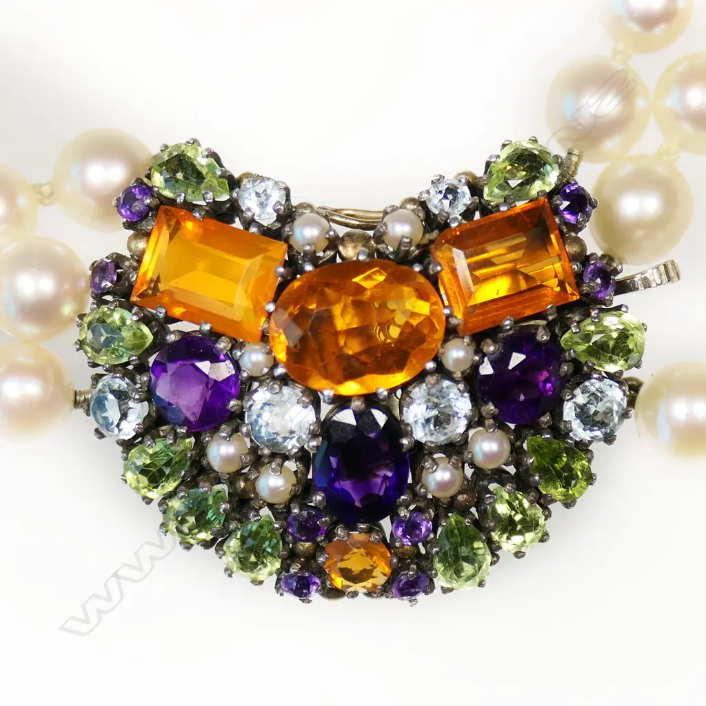 An uncommon triple strand cultured pearl necklace with gem stone clasp by Dorrie Nossiter, Image 1++