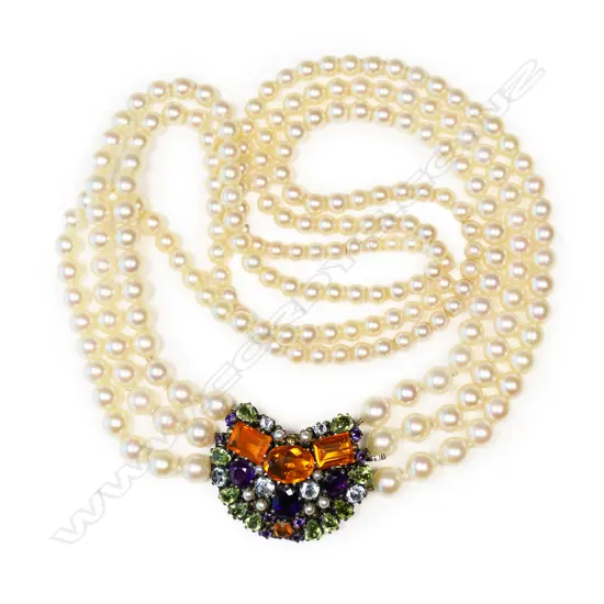 An uncommon triple strand cultured pearl necklace with gem stone clasp by Dorrie Nossiter,
